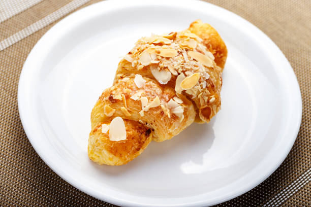 istock fresh croissant on a plate on the table. 1072247382