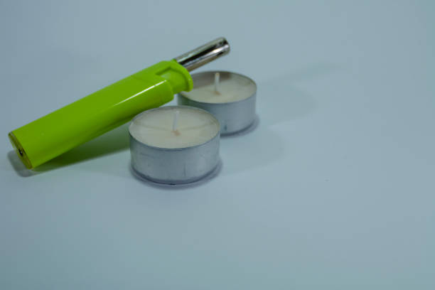 istock Candles and a green lighter on white isolated background. 1072247774