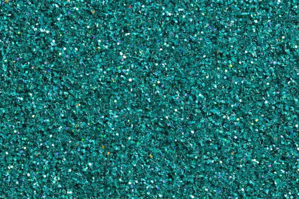 Bright turquoise shining abstract background with glitter. High resolution photo.
