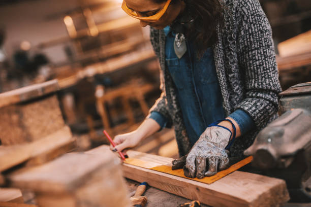 istock Close up of female carpenter working in workshop. Female doing male's work concept. 1072253248