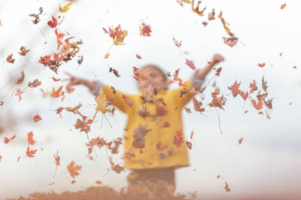 istock Young girl playing with leaves 1072254434