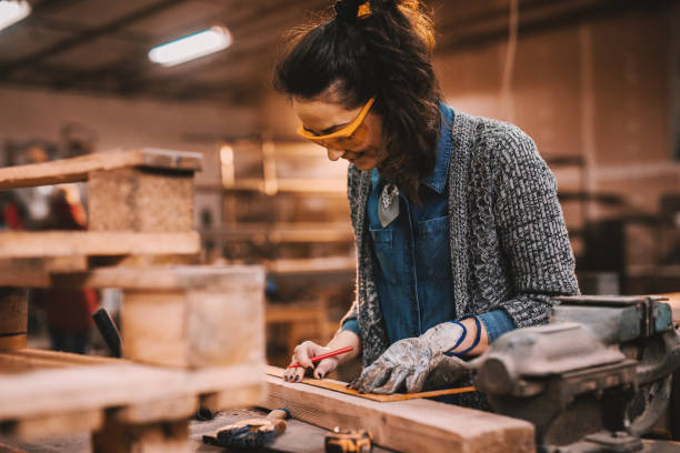 istock Female carpenter working in workshop. Female doing male's work concept. 1072255112