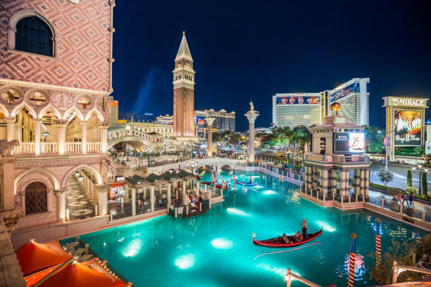 Las Vegas Strip with The Venetian Resort Hotel illuminated at night, Nevada, USA SEPTEMBER 20, 2017 - LAS VEGAS: Downtown Las Vegas with world famous Strip and The Venetian and The Mirage Resort Hotels illuminated at night, Nevada, USA game resort pictures stock pictures, royalty-free photos & images