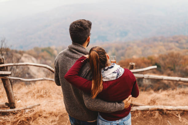 istock Happy Caucasian couple enjoying the view while hugging and standing at view point. Autumn season. 1072257010