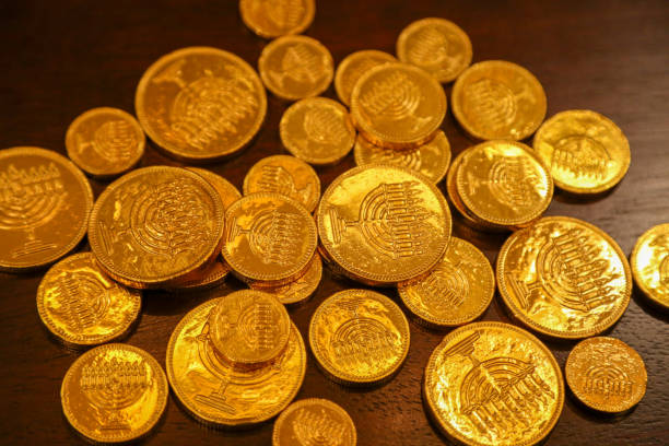 Hanukkah candy gold gelt coins on a brown table