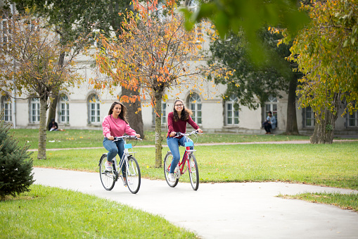 University students having fun with bicycles.