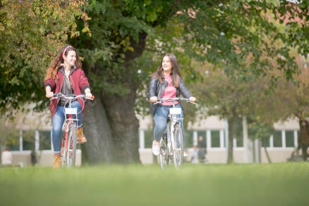 istock University students riding bikes outdoors 1072264002