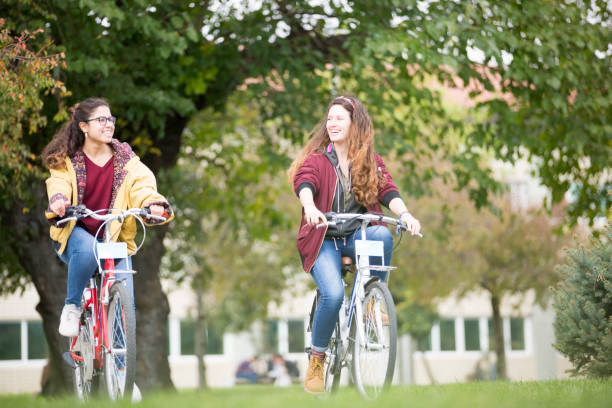 istock University students riding bikes outdoors 1072264018