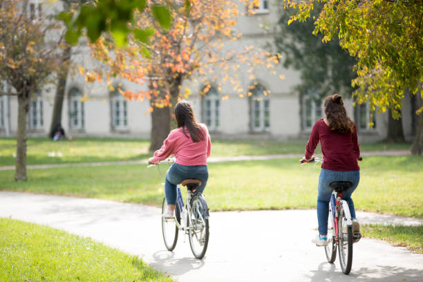 istock University students riding bikes outdoors 1072264070