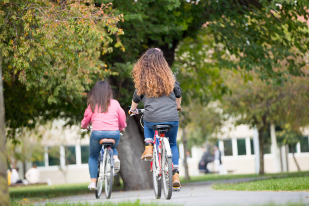 istock University students riding bikes outdoors 1072264090