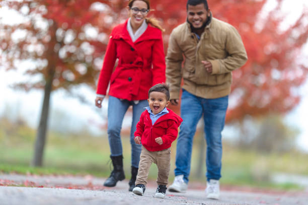 istock Baby walking outside with parents 1072267924