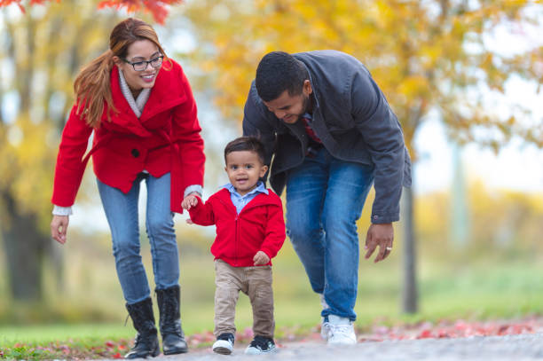 istock Toddler walking with parents outside 1072267936