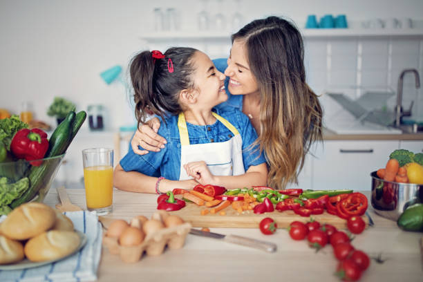 istock Mother is playing with her daughter in the kitchen 1072267992