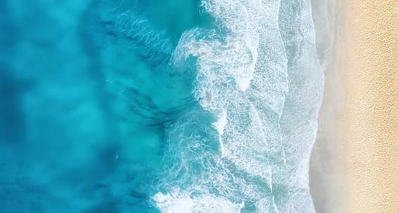 Beach and waves from top view. Turquoise water background from top view. Summer seascape from air. Top view from drone. Travel concept and idea