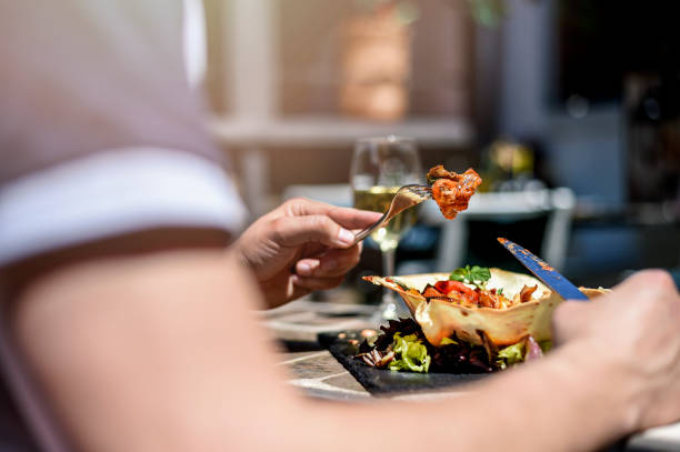 istock Man eating white meat in tortilla cup 1072268466