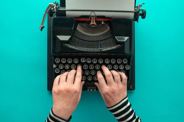 istock Woman typing vintage typewriter, top view 1072275786