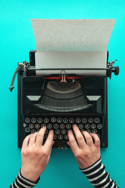 woman typing vintage typewriter, top view - author writing retro revival women imagens e fotografias de stock