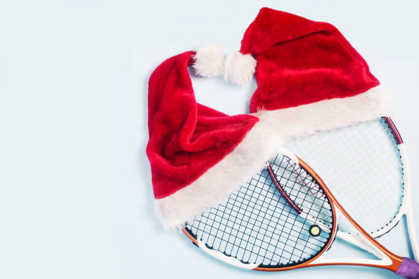 istock santa hat on tennis racket on white background 1072278618