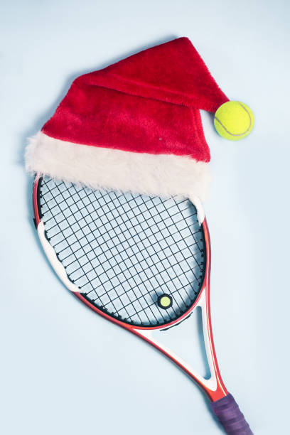 santa hat on tennis racket on white background - tennis ball tennis racket tennis vertical imagens e fotografias de stock