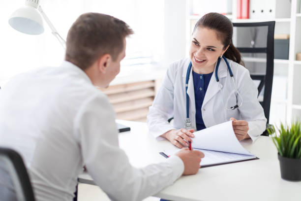 istock The young man at the doctor's office signs the documents. 1072287168