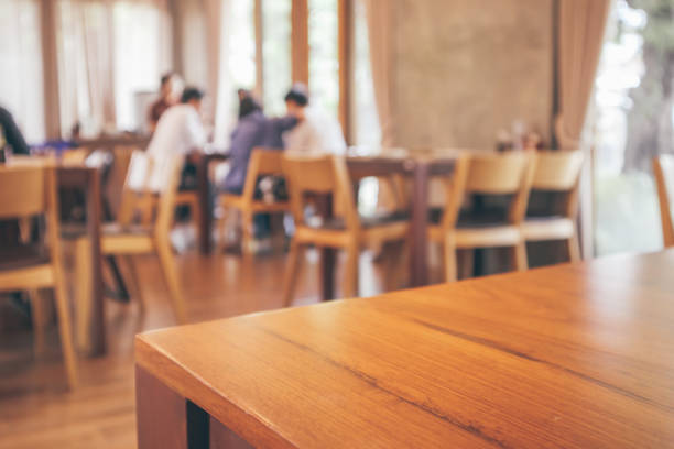 istock Restaurant interior with customer and wood table blur abstract background with bokeh light 1072287334