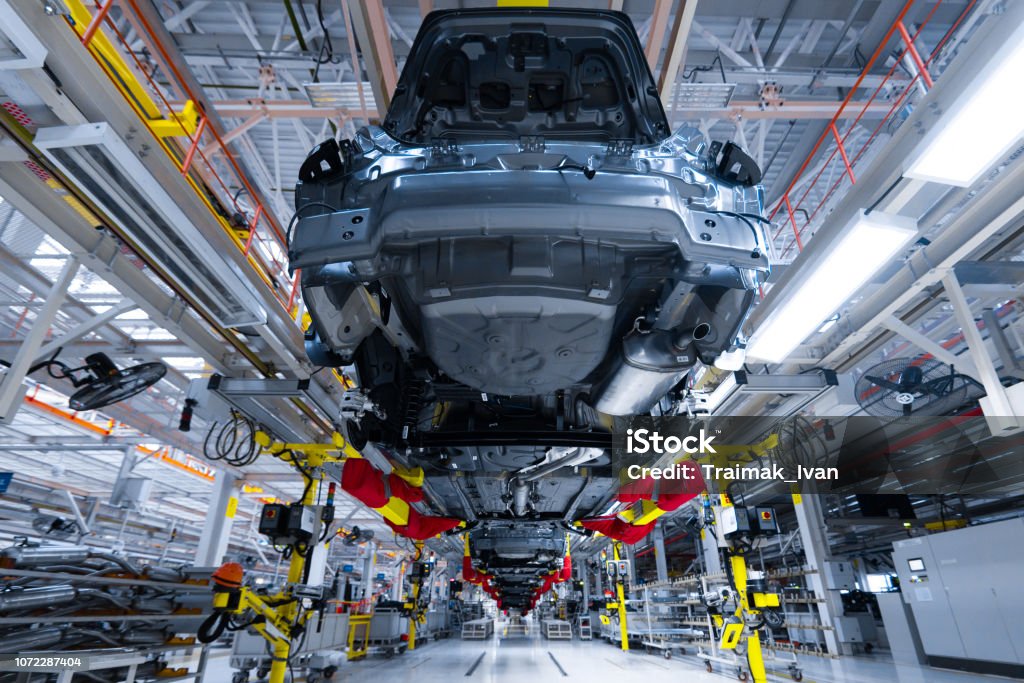 Movement of vehicles along the production line at the plant. Car Assembly shop. Car Assembly by parts Modern automobile production line, automated production equipment. Shop for the Assembly of new modern cars. The way of Assembly of the car on the Assembly line at the plant Manufacturing Stock Photo