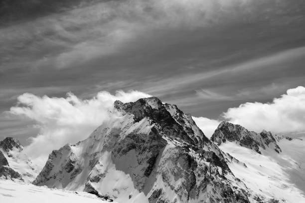 istock High mountains in snow and sunlight sky with clouds at cold winter day 1072287782