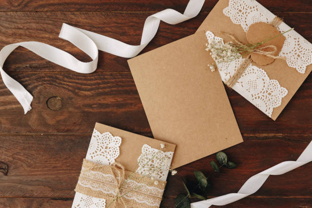 istock Flat lay Tools DIY on a wooden table: paper, scissors, thread, olive branch. Self-made envelope for letters. Top view. 1072288226