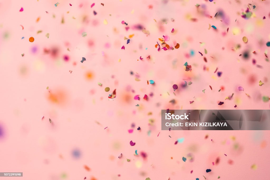 Confetti rain on pink background Confetti rain on pink background. Directly above shot. Confetti Stock Photo