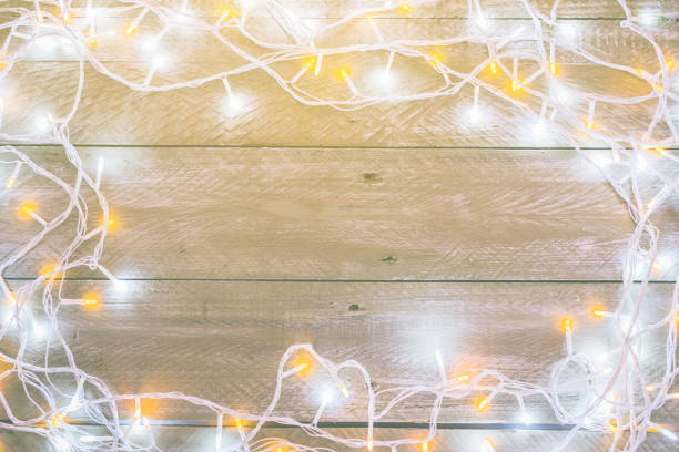istock christmas light wire on wooden floor background with free copy space 1072292168