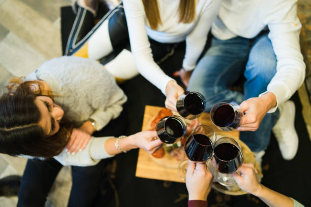 istock High angle view On Hands Toasting With Glasses Of Wine 1072292274