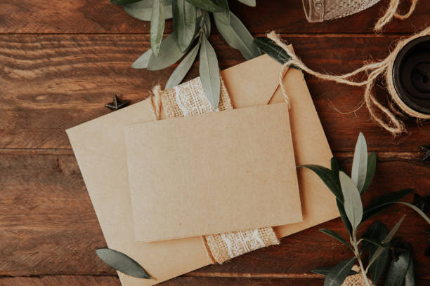 istock Empty greetings card with envelope and olive branches on wooden background 1072292286