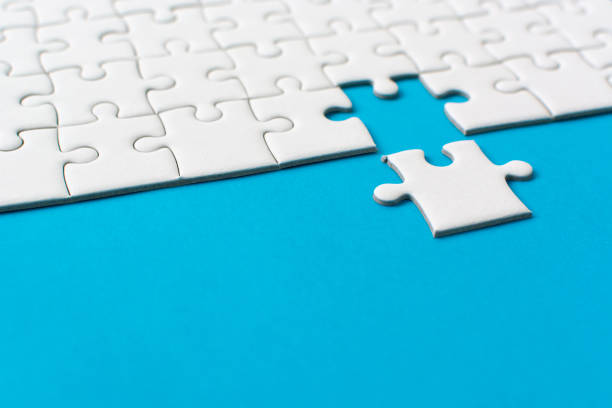 istock White jigsaw puzzle on blue background. Team business success partnership or teamwork. 1072296422