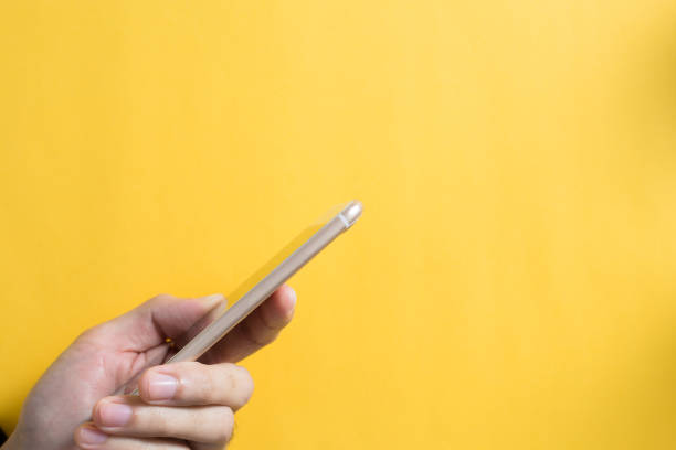 istock Smartphone with hand against blank bacoground 1072303472