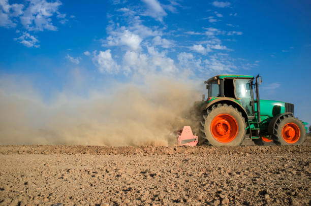 istock Farm tractor preparing dusty soil affected by drought 1072304832