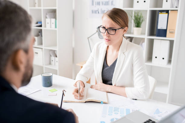 istock Displeased lady boss talking to colleague 1072306764