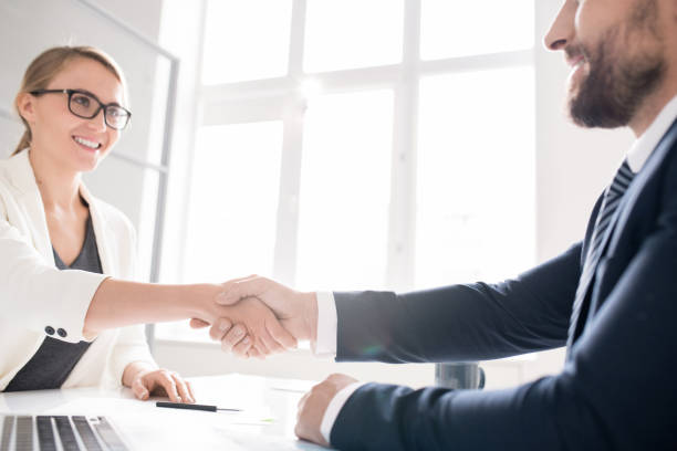 istock Cheerful business partners making handshake in office 1072306768