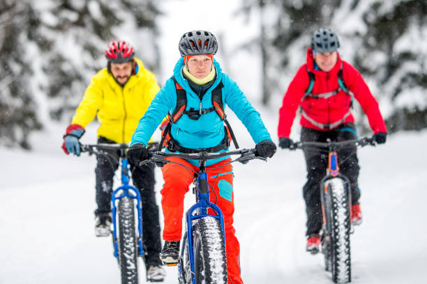 istock Front view of three friends on fatbikes cycling on snow 1072309410