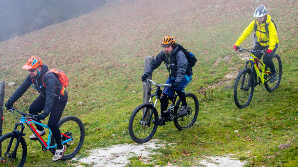 istock Three mountain bikers riding in line on a foggy day 1072309700