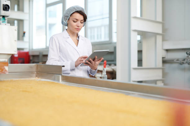 istock Female Worker Overseeing Food Production 1072311020