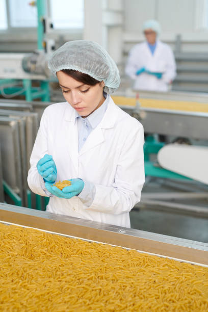 istock Young Woman at Production Line 1072311188