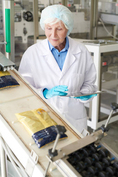 istock Smiling Senior Woman at Packaging Line 1072311290