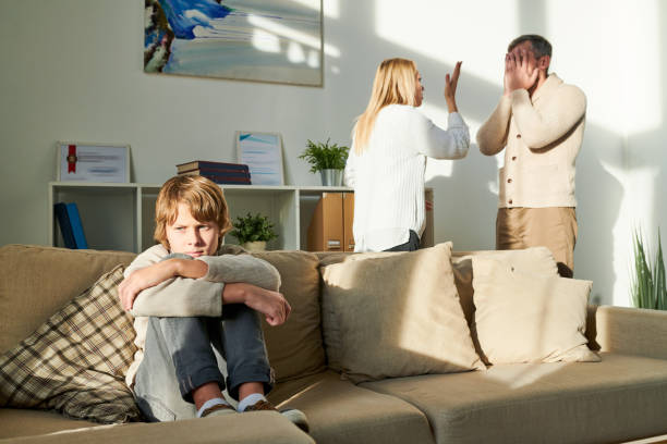istock Depressed boy suffering from parents conflict 1072312008