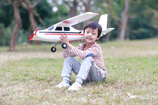 Boy hand holding a toy plane