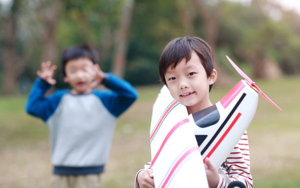 istock Boy hand holding a toy plane 1072313522