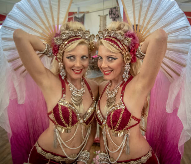 istock Macedonian belly dancer rehearses with her own image in a dancers mirror. 1072313540