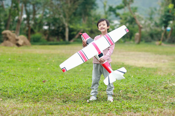 istock Boy hand holding a toy plane 1072313562