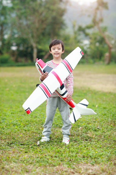 istock Boy hand holding a toy plane 1072313572