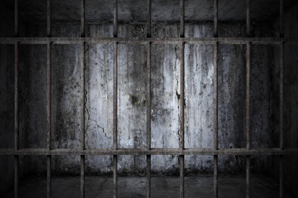 istock prison rusted metal bars cell lock with dark and bright in the jail 1072314100