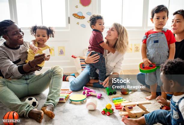 Diverse Children Enjoying Playing With Toys - Fotografias de stock e mais imagens de Criança - Criança, Pais, Infantário